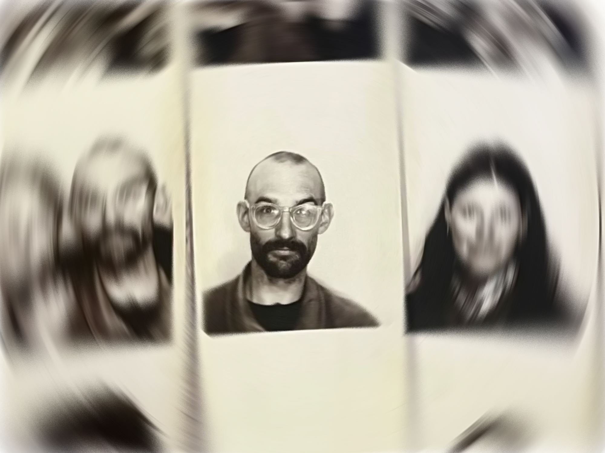 Black and white portrait of a man with glasses and a beard.